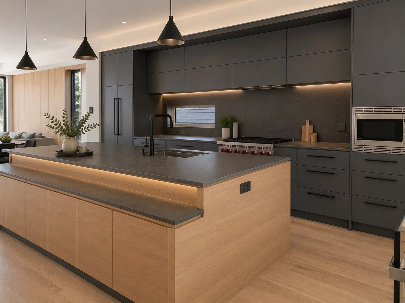 Charcoal and white oak kitchen with a two-level island, black cone pendants and a professional range, by NewGen Renovations Vaughan