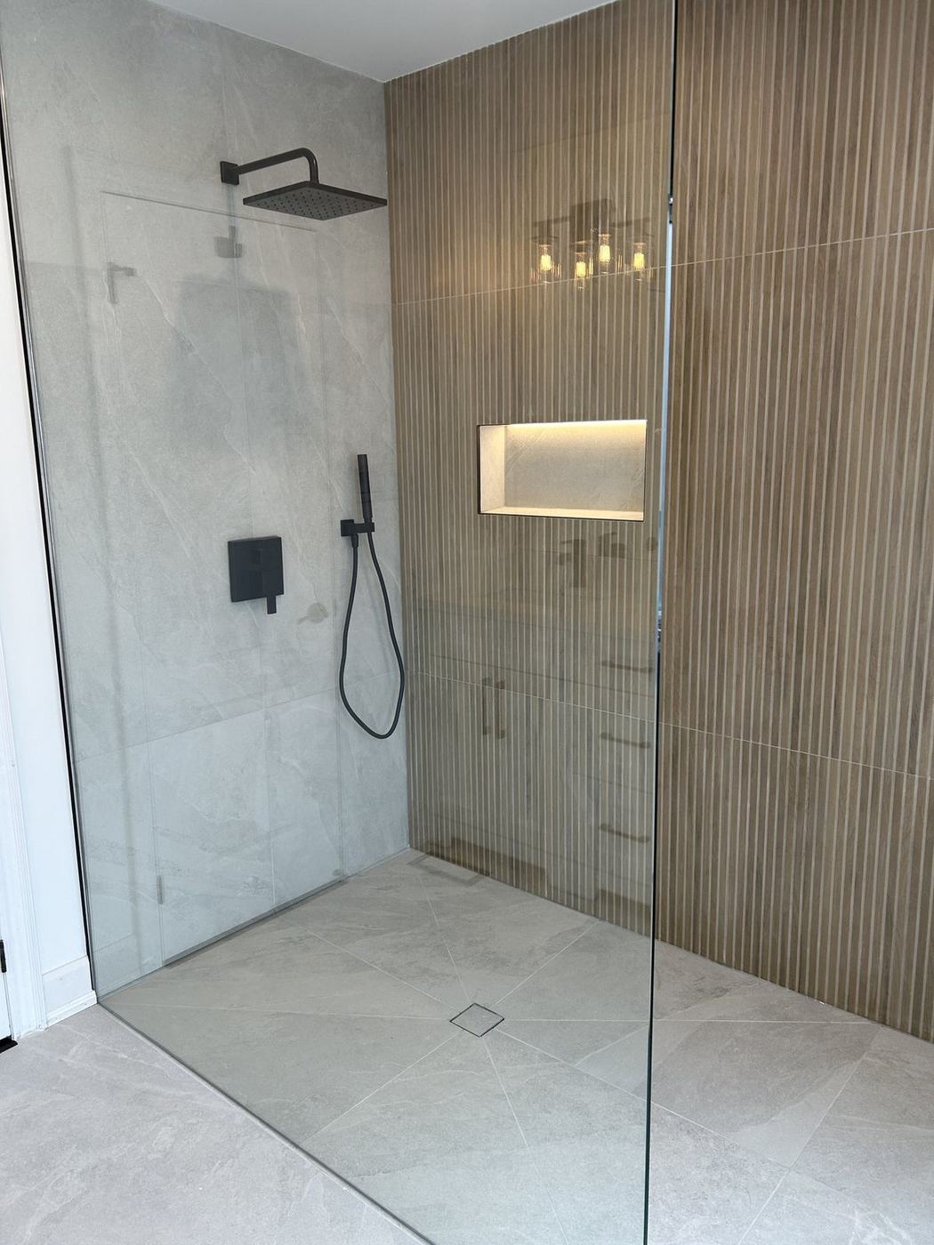 Curbless walk-in shower that replaced an unused corner tub in a bathroom renovation by NewGen Renovations Vaughan